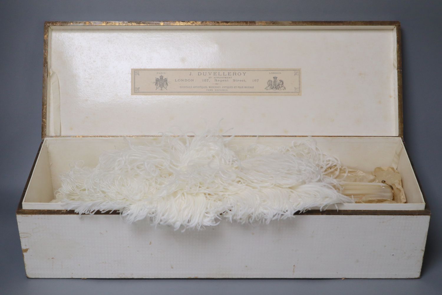 An ostrich feather fan with mother of pearl sticks, in J. Duvelleroy box, Regent Street, fan height 46cm